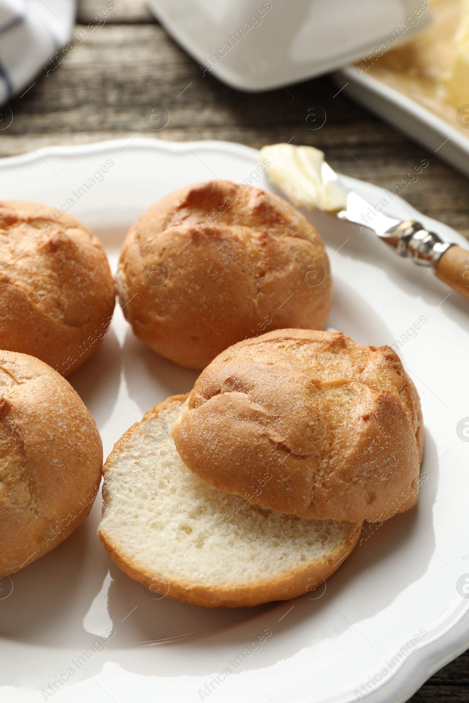 Photo of Plate with homemade tasty buns on table, closeup