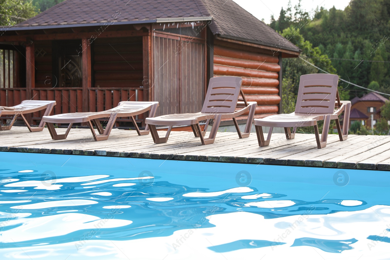 Photo of Outdoor swimming pool and sunbeds in luxury hotel