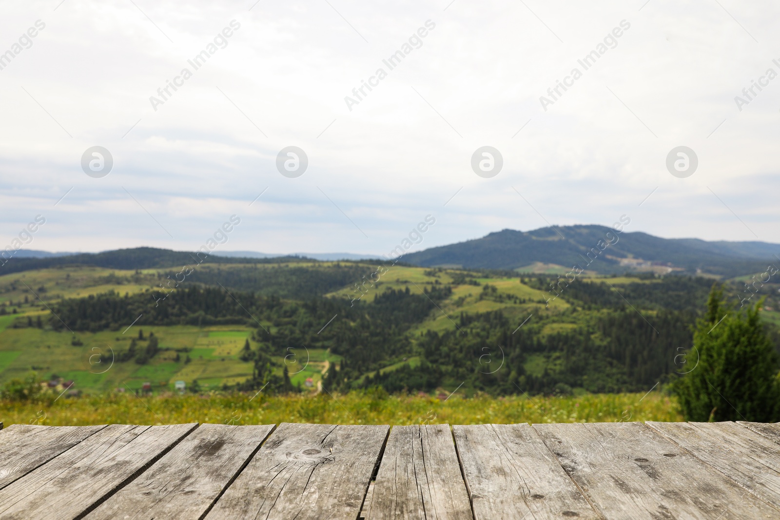 Photo of Empty wooden surface in mountains. Space for text