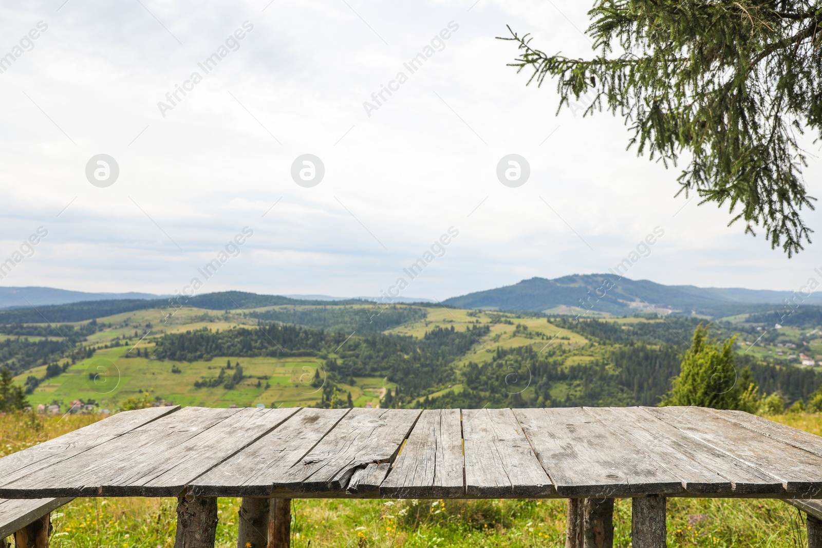 Photo of Empty wooden table in mountains. Space for text