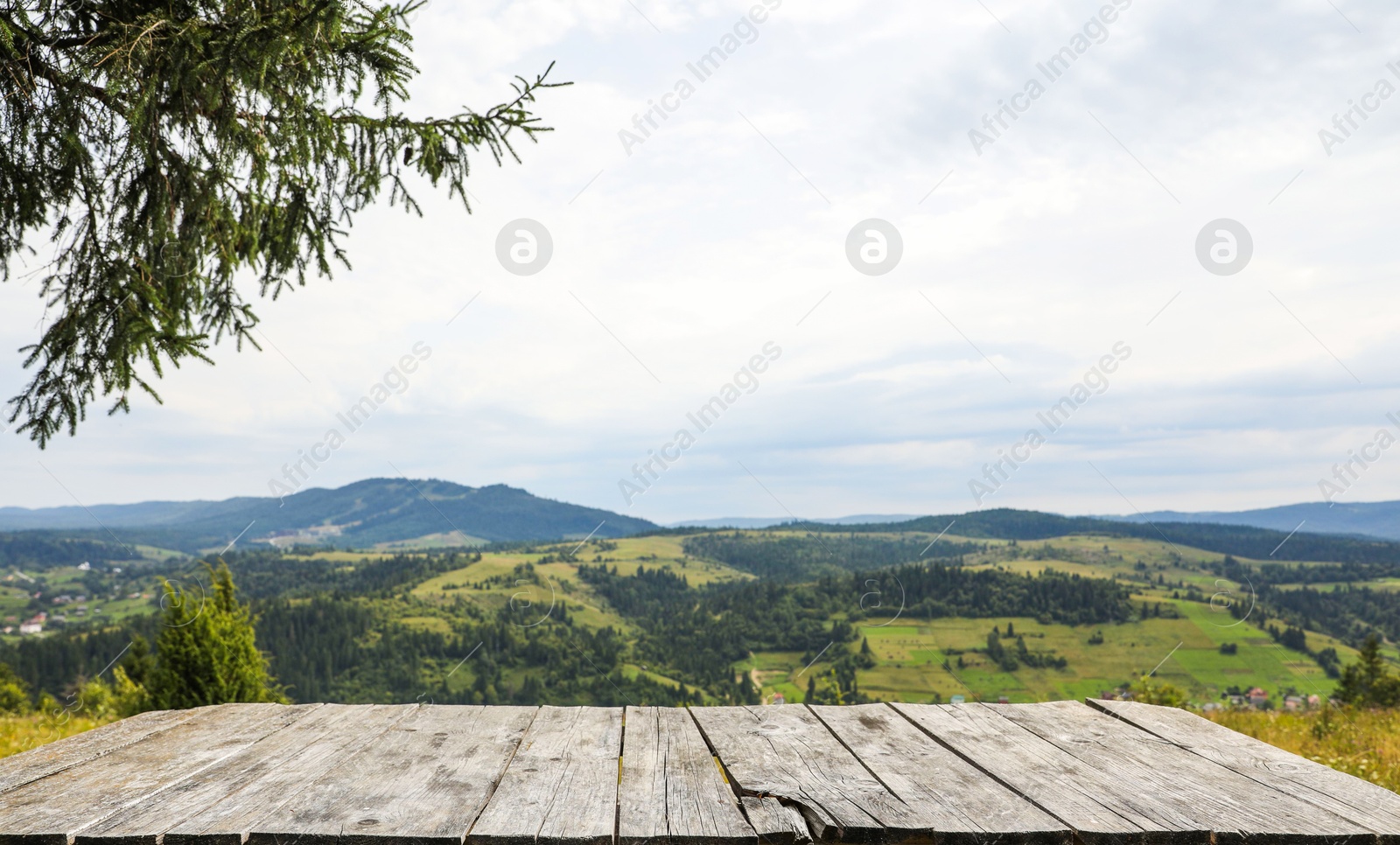 Photo of Empty wooden surface in mountains. Space for text