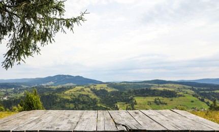 Photo of Empty wooden surface in mountains. Space for text