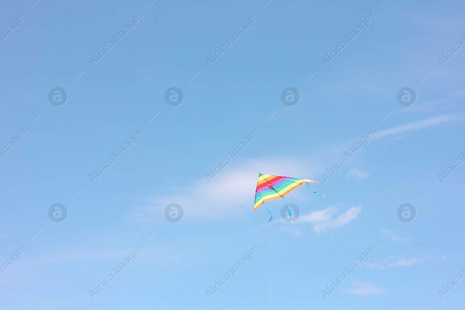 Photo of One colorful kite flying in blue sky