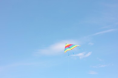 One colorful kite flying in blue sky