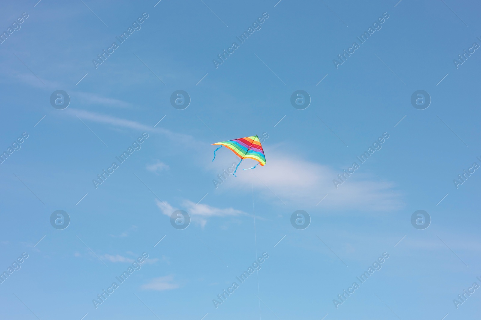 Photo of One colorful kite flying in blue sky