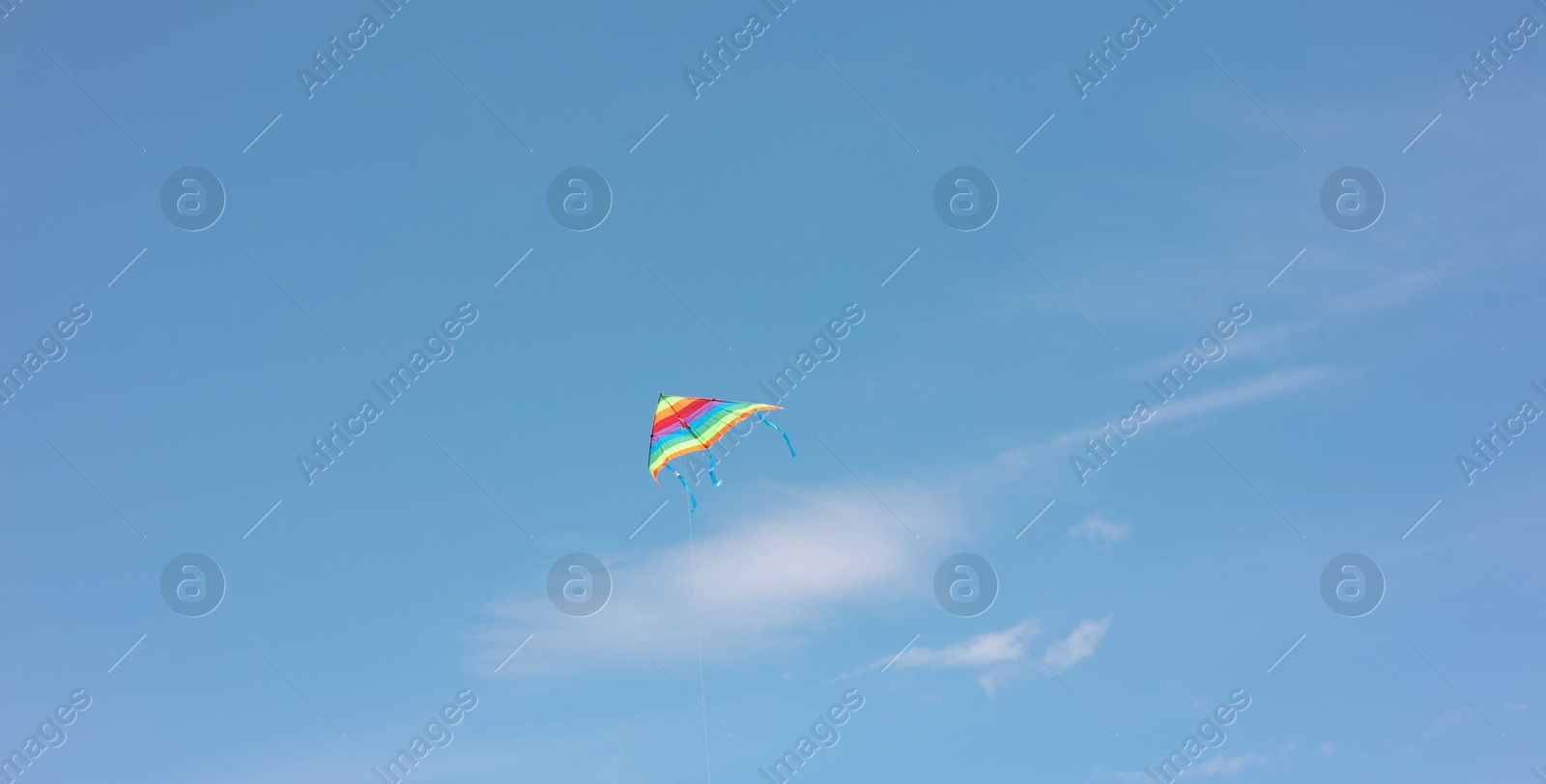 Photo of One colorful kite flying in blue sky