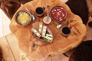 Different dishes of Ukrainian cuisine on wooden table in cafe, flat lay