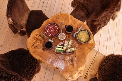 Different dishes of Ukrainian cuisine on wooden table in cafe, flat lay