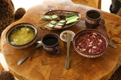 Photo of Different dishes of Ukrainian cuisine on wooden table in cafe