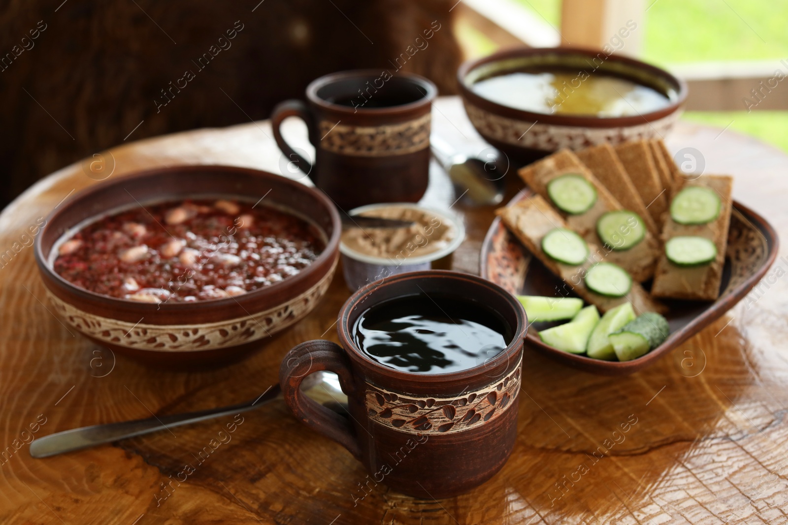 Photo of Different dishes of Ukrainian cuisine on wooden table in cafe