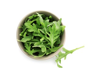 Photo of Fresh arugula leaves in bowl isolated on white, top view