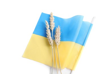 Ears of wheat and Ukrainian national flag isolated on white