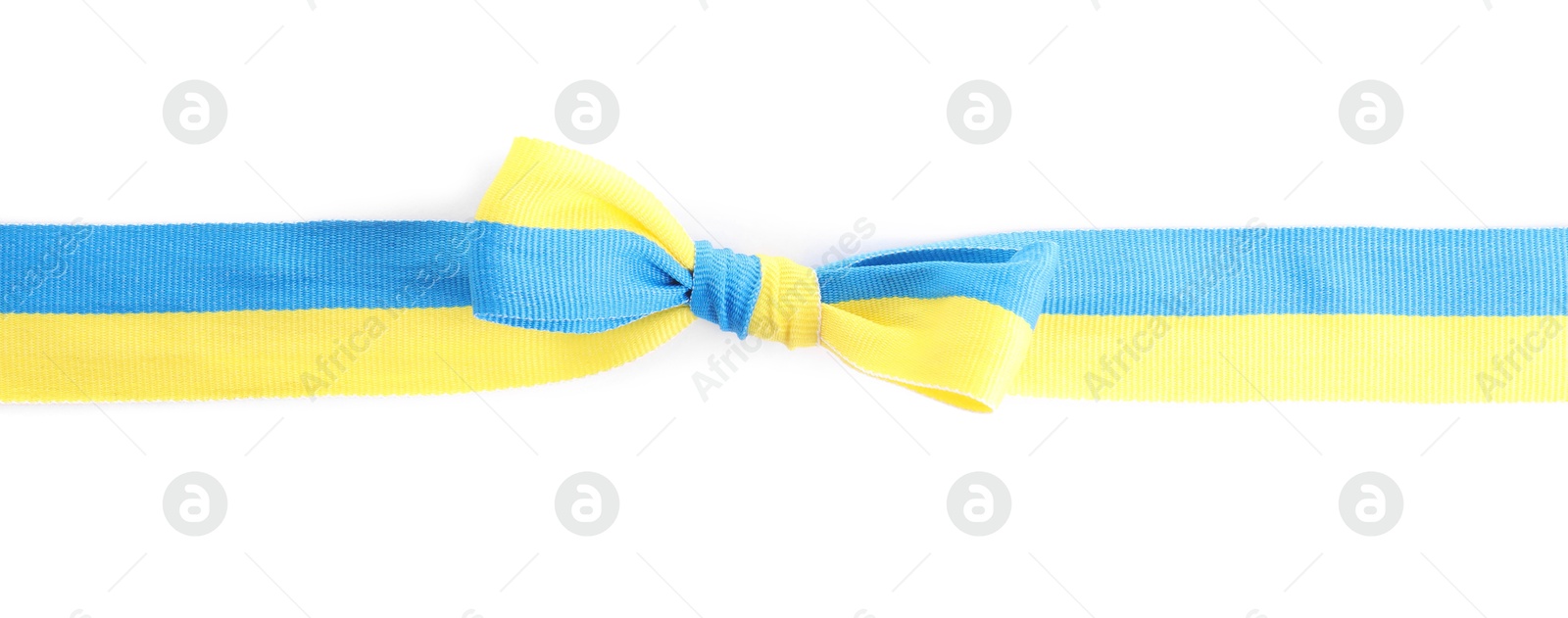 Photo of Ribbon with bow in colors of Ukrainian national flag isolated on white, top view