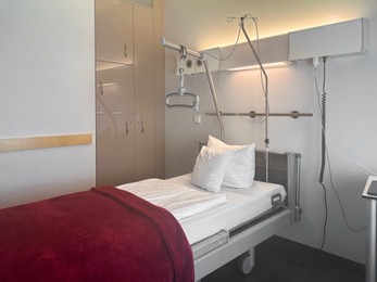 Photo of Modern interior of hospital ward with bed