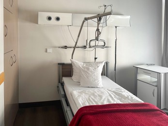 Photo of Modern interior of hospital ward with bed