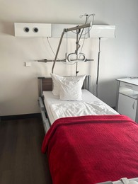 Photo of Modern interior of hospital ward with bed