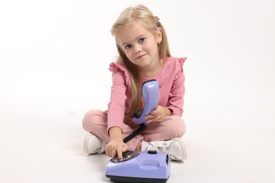 Cute little girl with telephone on white background