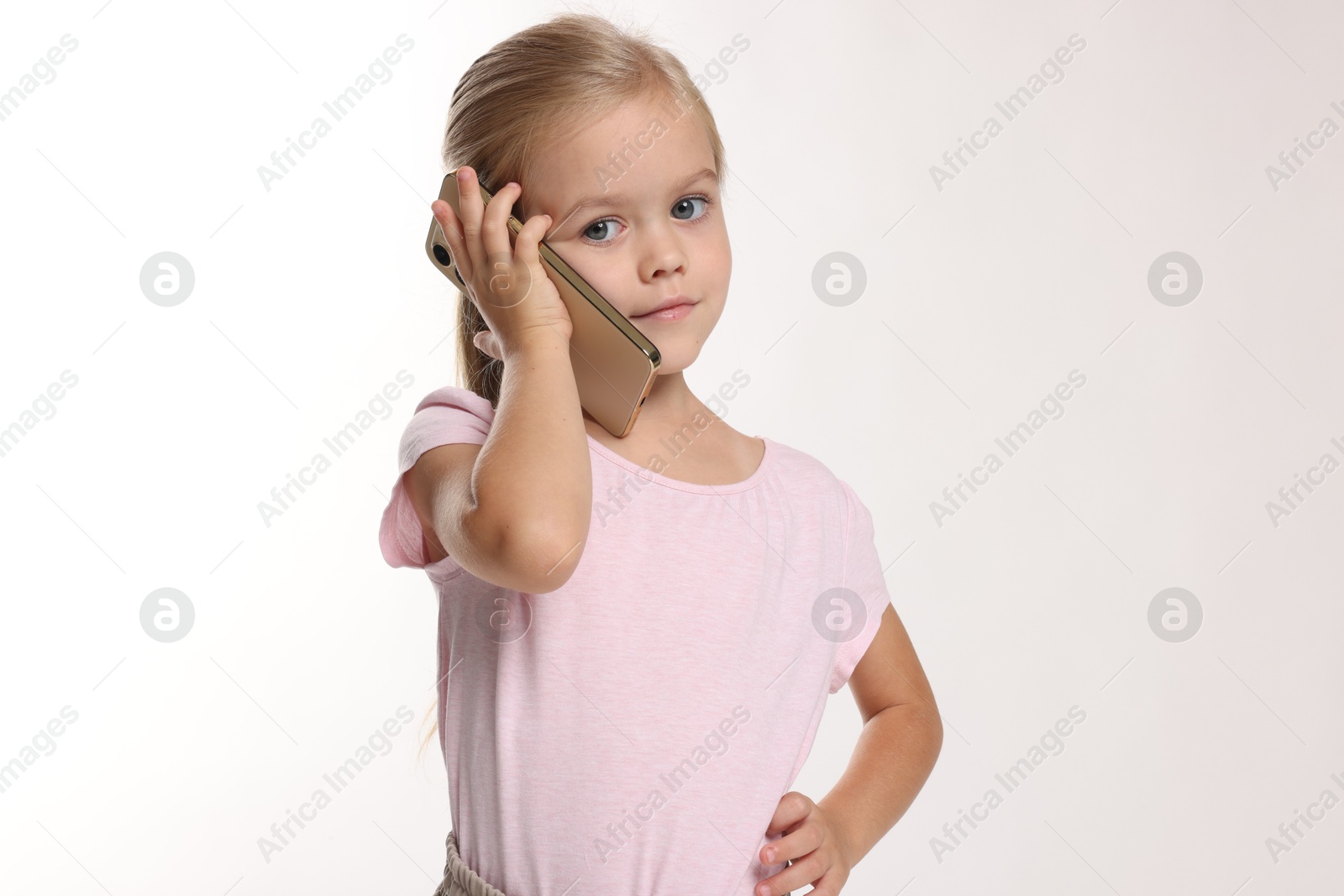 Photo of Cute little girl talking on smartphone against white background