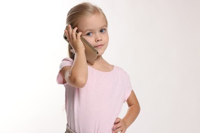 Cute little girl talking on smartphone against white background