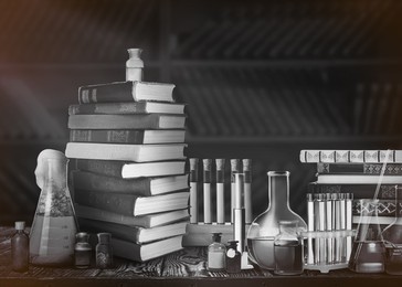 Image of Chemist's workplace with old books and laboratory glassware, vintage style