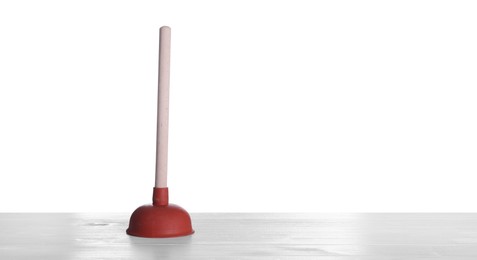 Photo of Plunger on white wooden table. Pipe cleaning tool