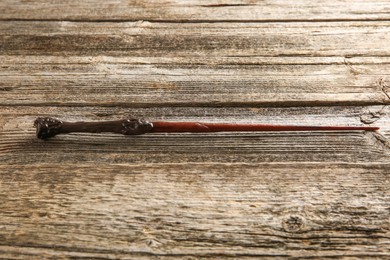 Photo of One old magic wand on wooden table