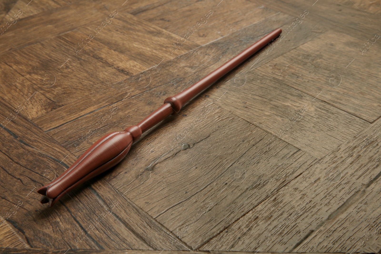 Photo of One magic wand on wooden table, closeup