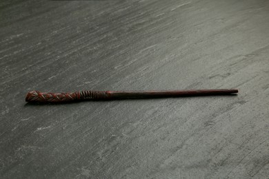 Photo of One old magic wand on black table