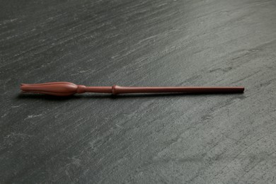 Photo of One old magic wand on black table