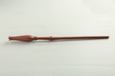 Photo of One old magic wand on white wooden table