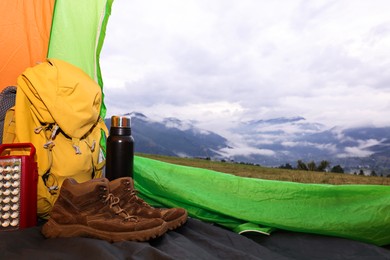 Picturesque view of mountain from tent with camping equipment