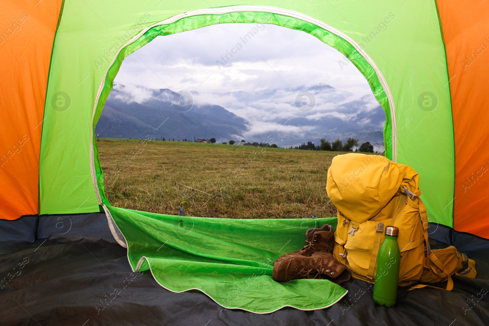 Photo of Picturesque view of mountain from tent with camping equipment