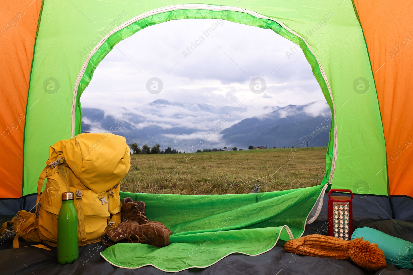 Photo of Picturesque view of mountain from tent with camping equipment