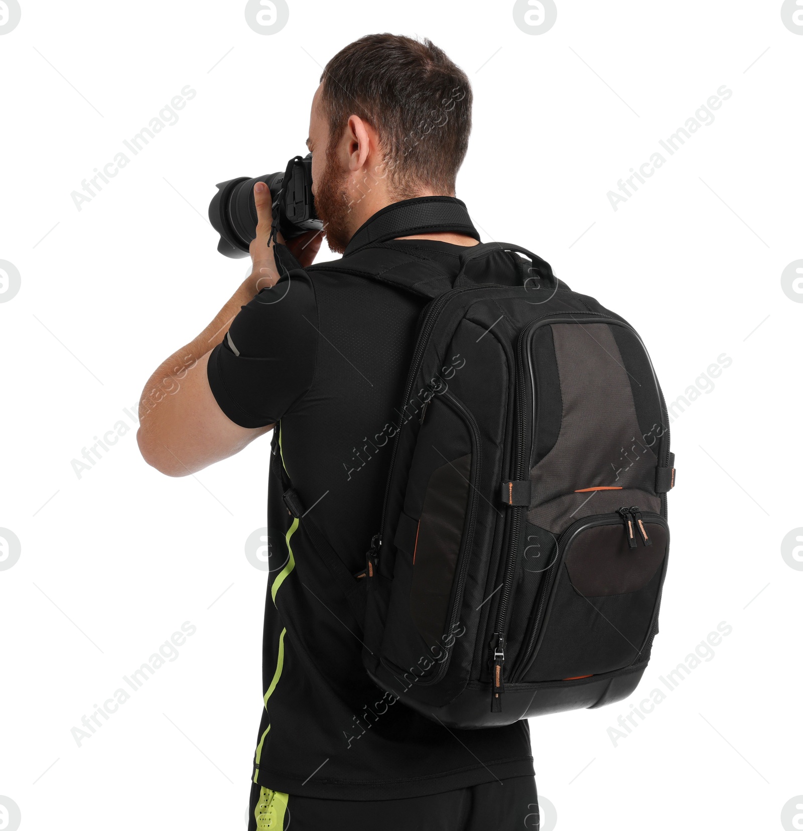 Photo of Photographer with backpack and camera taking picture on white background, back view