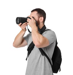 Photographer with backpack and camera taking picture on white background