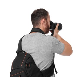 Photo of Photographer with backpack and camera taking picture on white background, back view