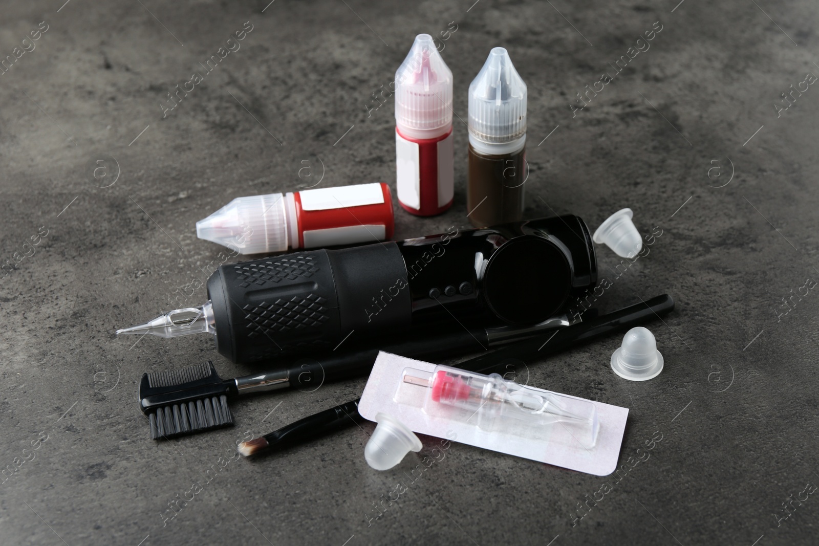 Photo of Permanent makeup equipment kit on grey background