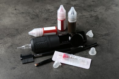 Permanent makeup equipment kit on grey background