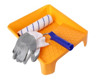 Paint roller brush, tray and gloves isolated on white