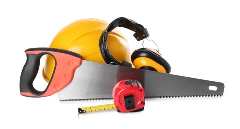 Saw, hard hat, measuring tape and earmuffs isolated on white. Construction tools