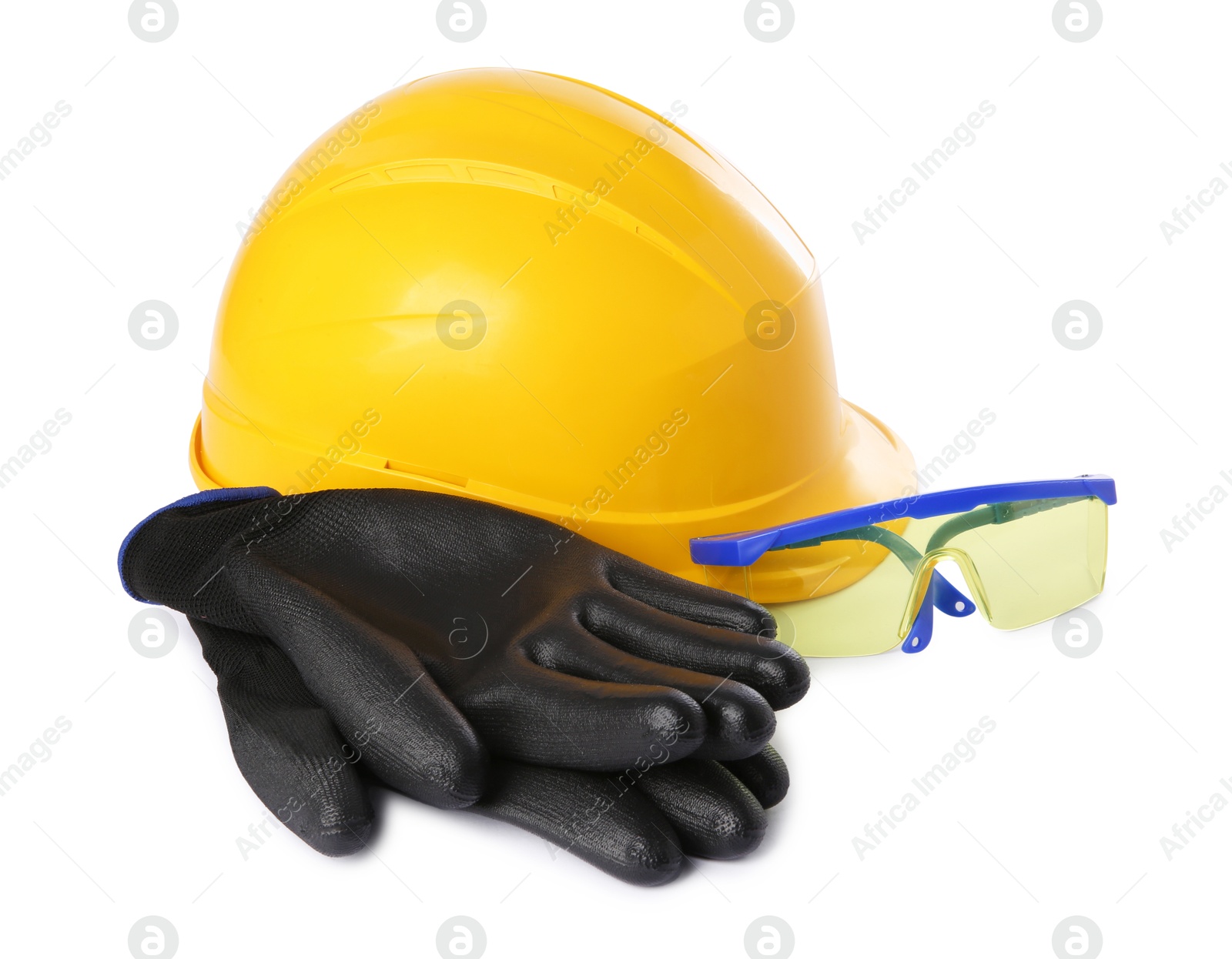 Photo of Yellow hard hat, gloves and goggles isolated on white. Safety equipment