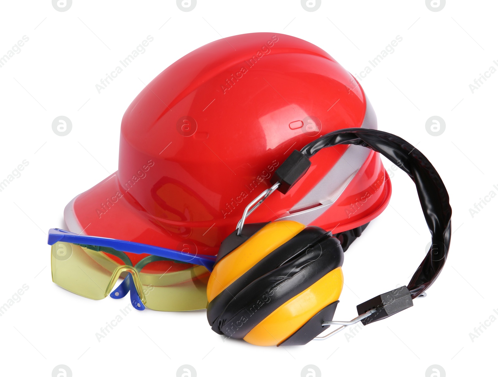 Photo of Orange hard hat, earmuffs and goggles isolated on white. Safety equipment