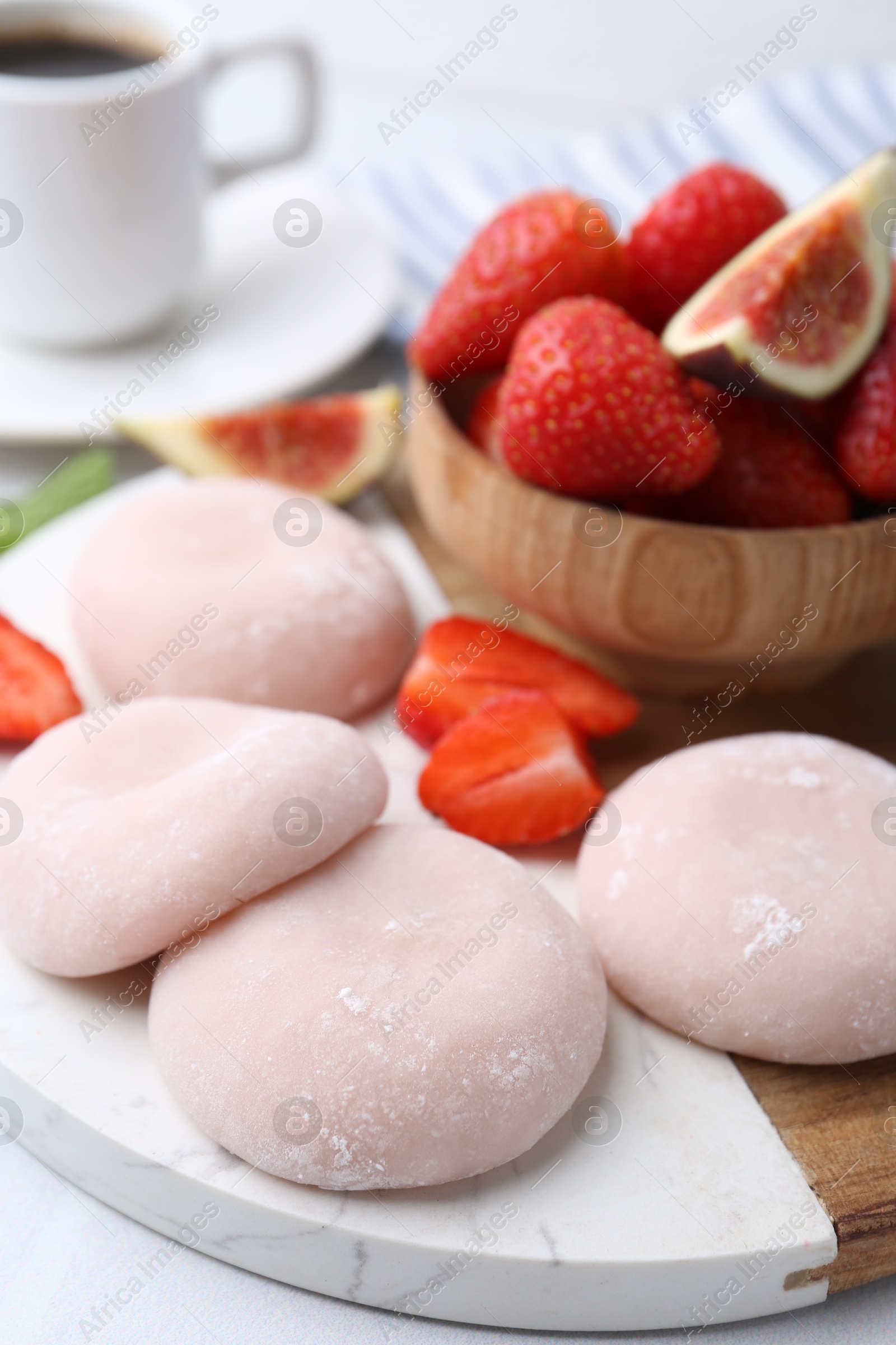 Photo of Delicious mochi, strawberries and fig on table, closeup