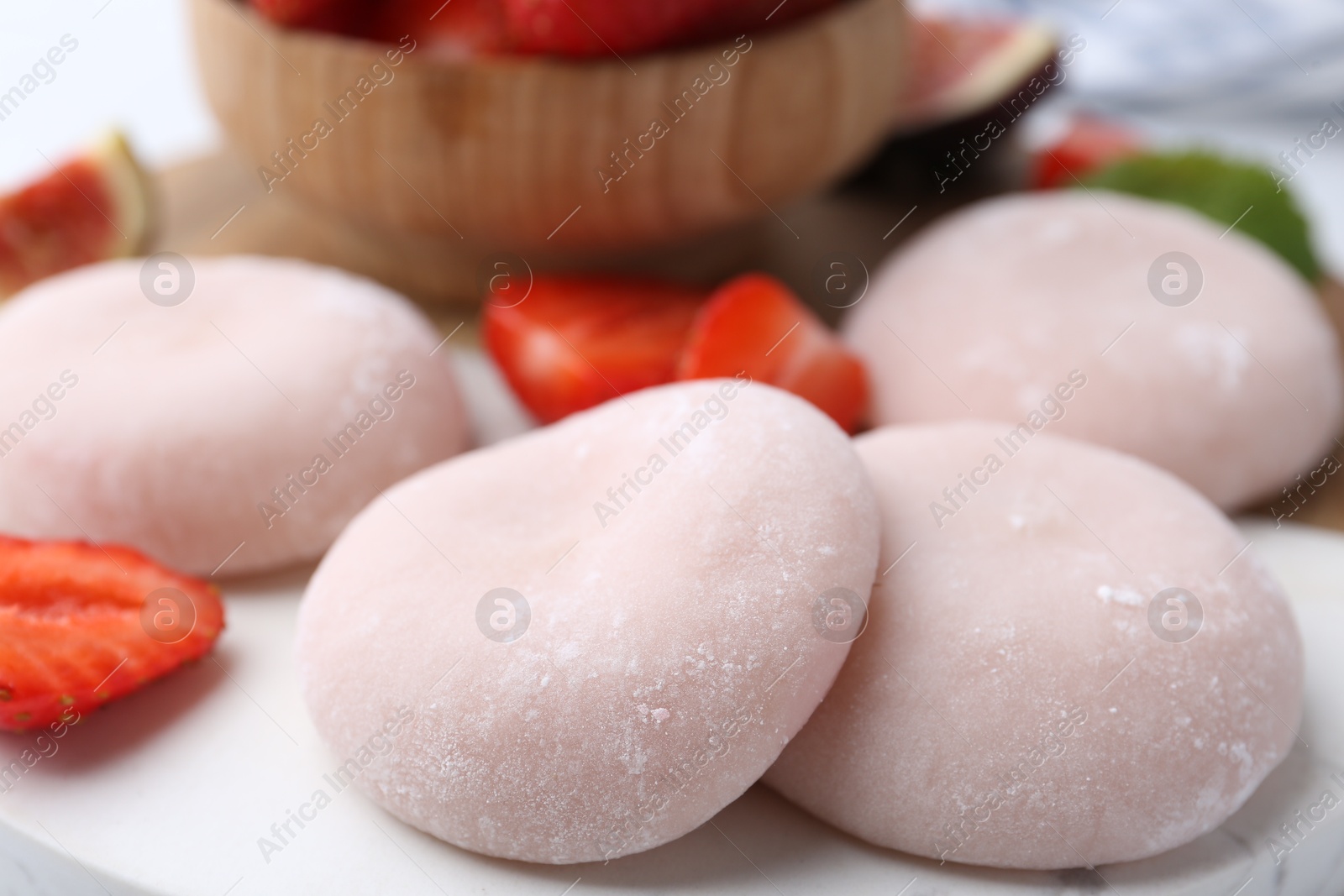 Photo of Delicious mochi and strawberries on table, closeup