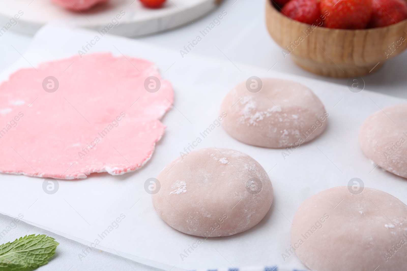 Photo of Tasty homemade mochi and dough on table, closeup