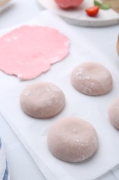 Photo of Tasty homemade mochi and dough on table, closeup