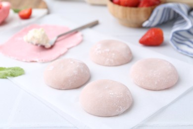 Photo of Tasty homemade mochi on white table, closeup