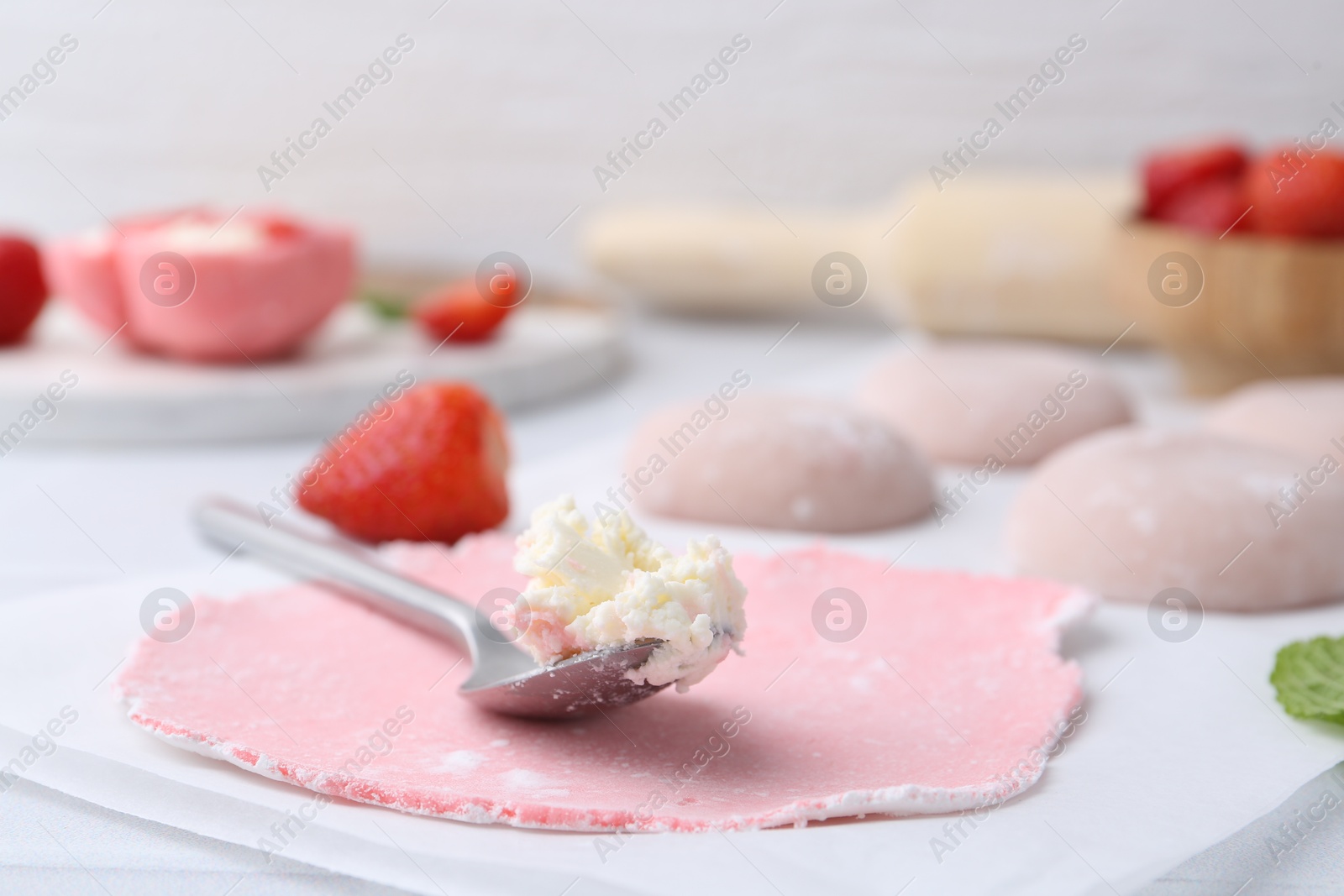 Photo of Dough for tasty homemade mochi and cream on table, closeup