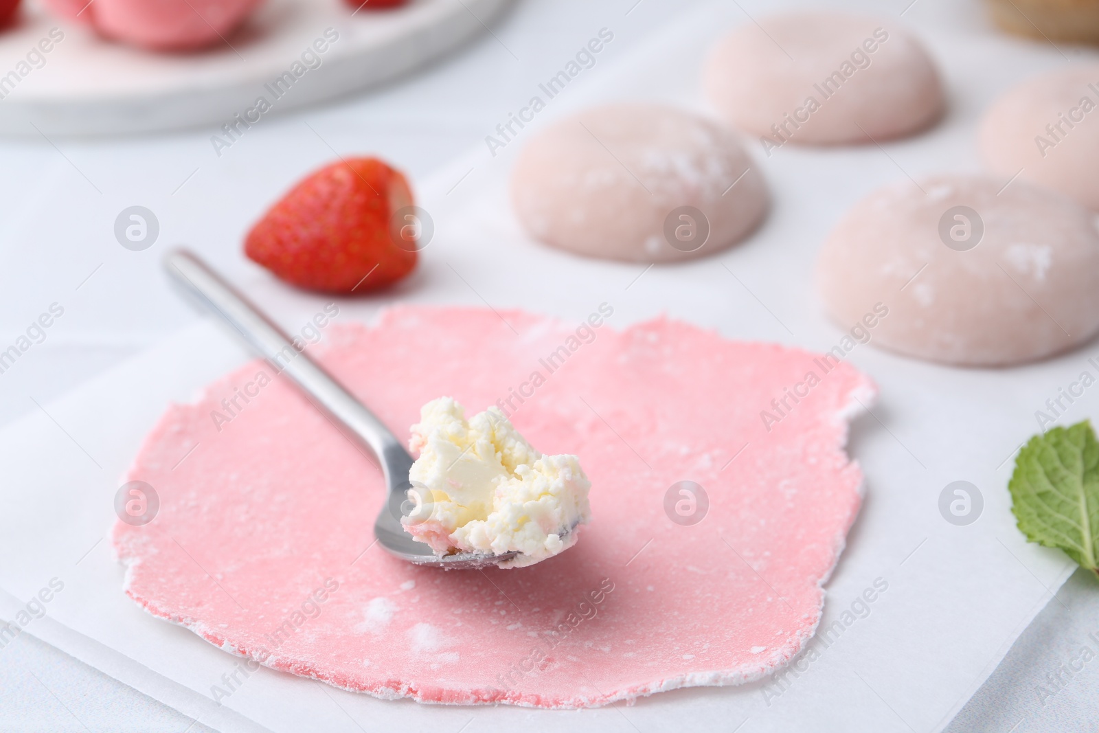 Photo of Dough for tasty homemade mochi and cream on table, closeup