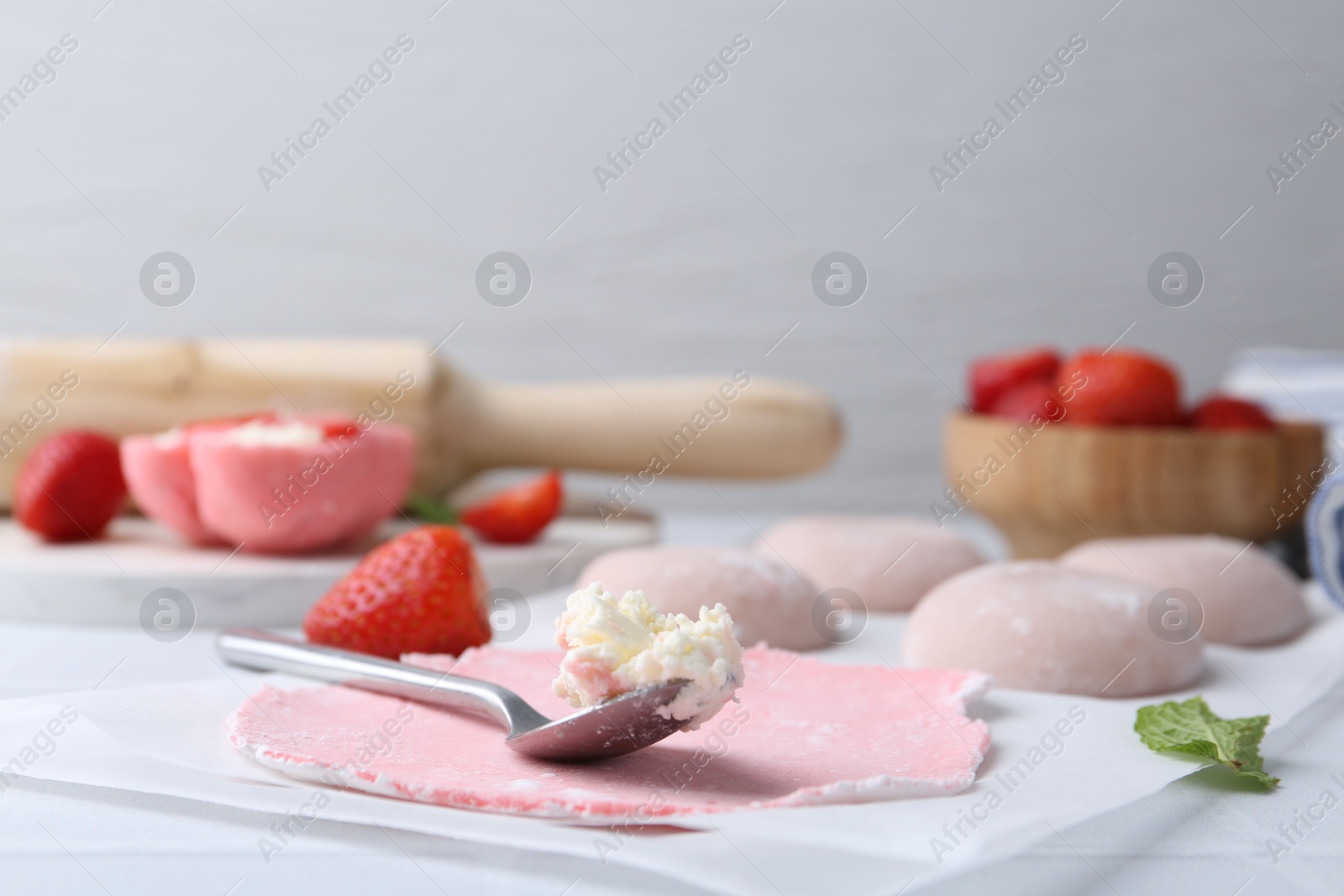 Photo of Dough for tasty homemade mochi and cream on table, closeup